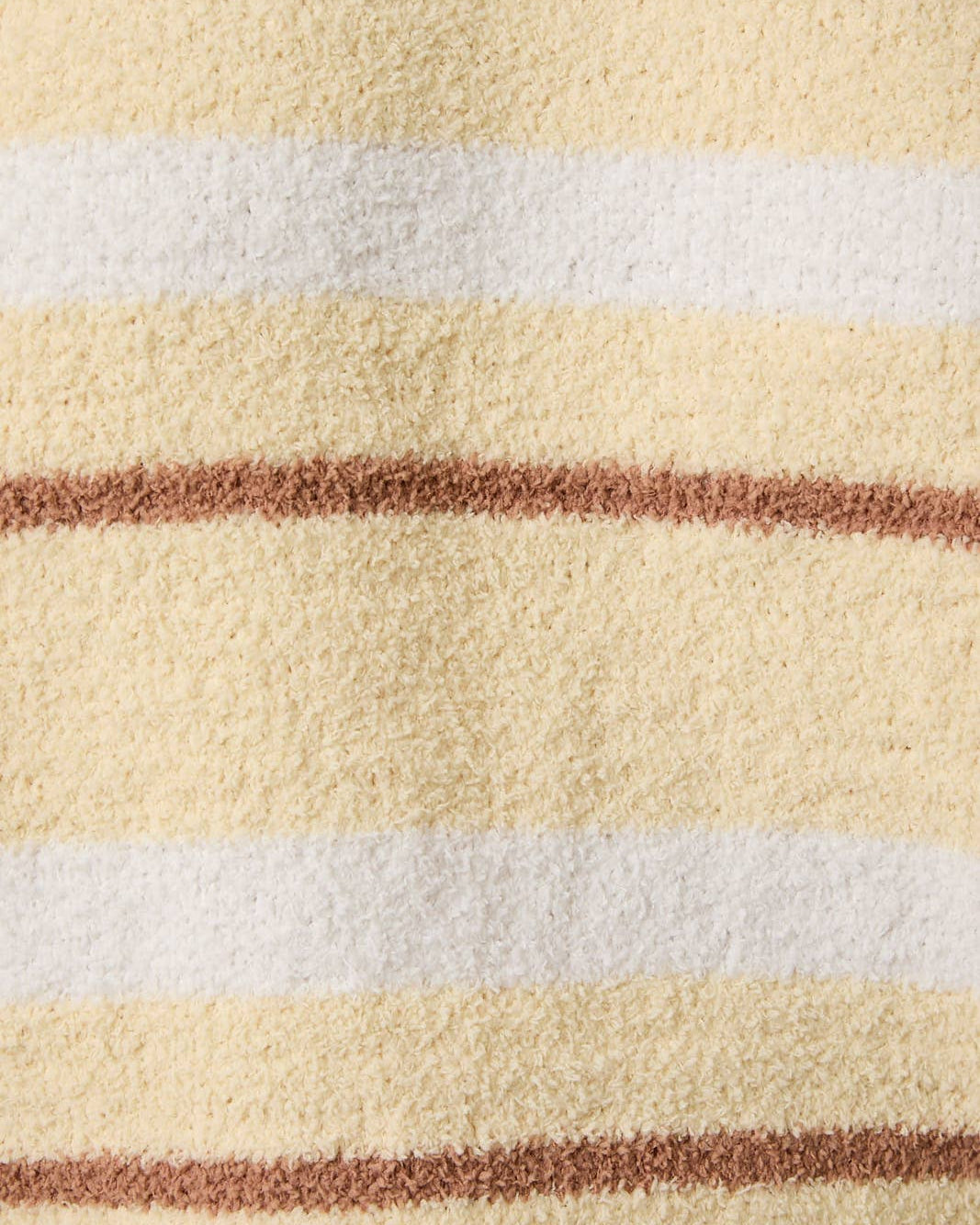 Close-up of a textured fabric with horizontal stripes in beige, white, and brown.