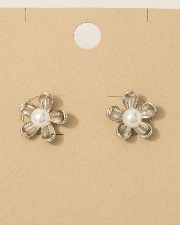 Flower-shaped earrings with pearls on a 'Wearbetter' branded card.