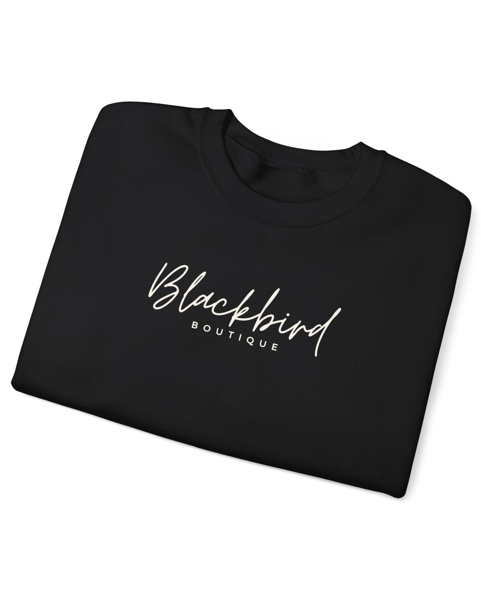 Folded black sweatshirt with 'Blackbird Boutique' text on a white background