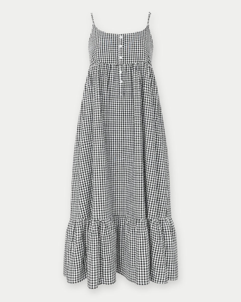 Black and white checkered dress with ruffled hem on a white background