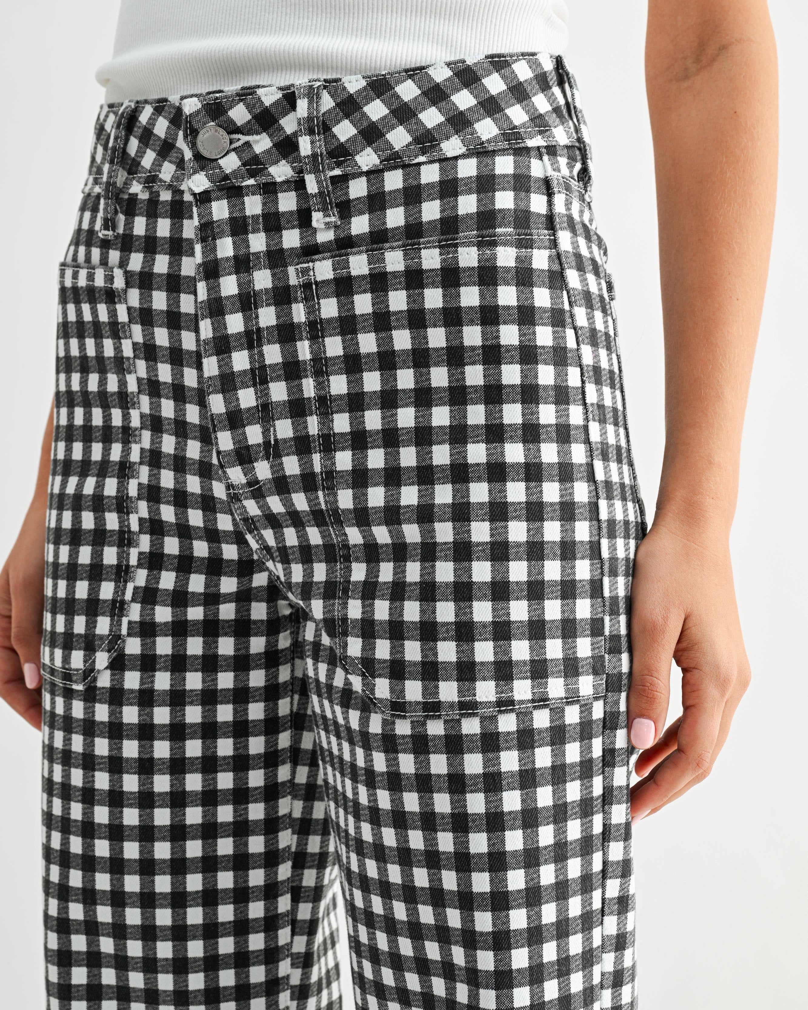Black and white checkered pants worn by a person on a white background