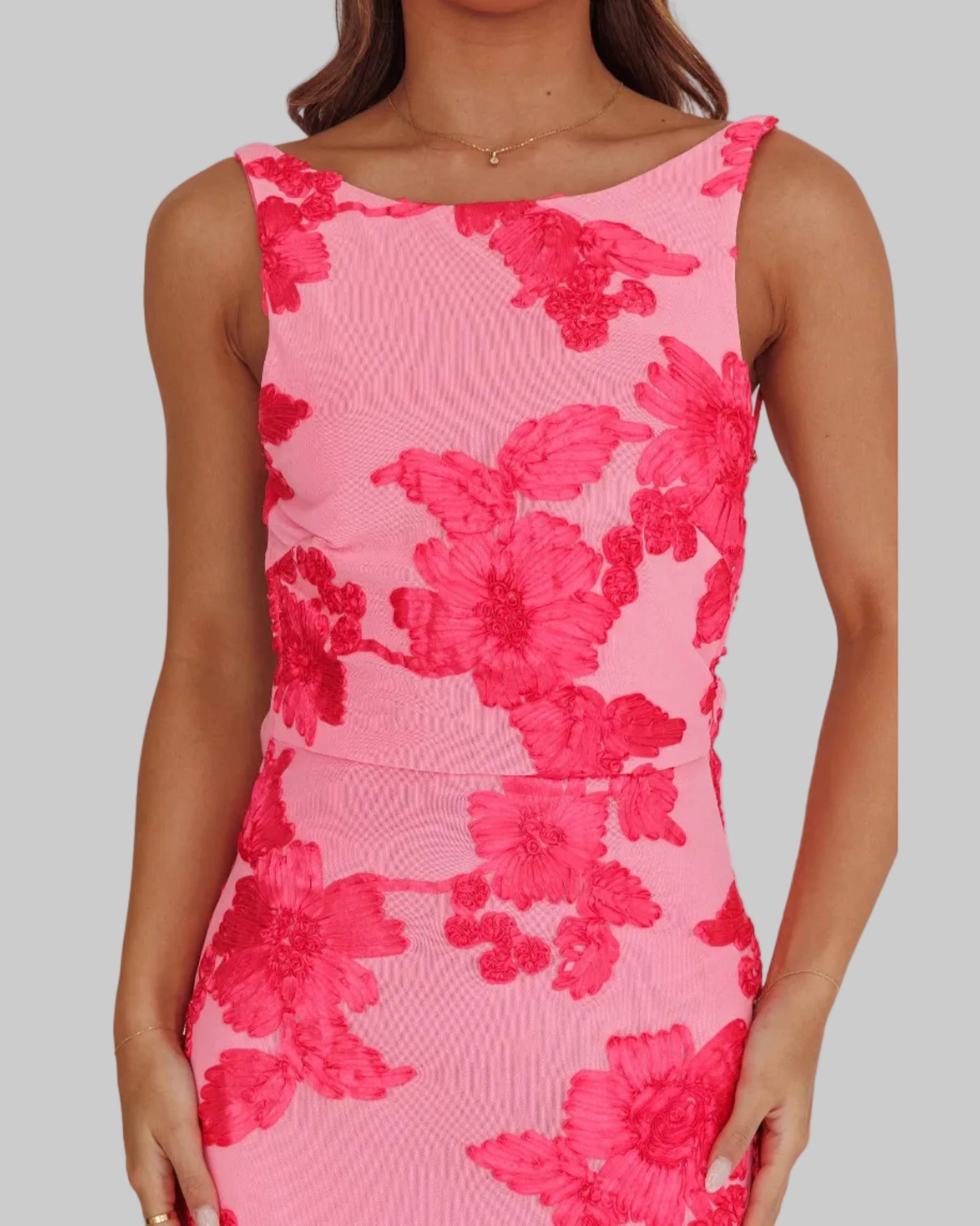 Pink floral dress worn by a model on a plain background