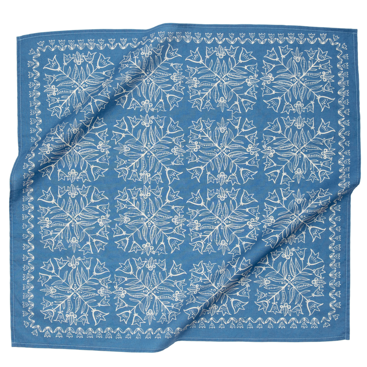 Blue fabric with white floral pattern, folded neatly.
