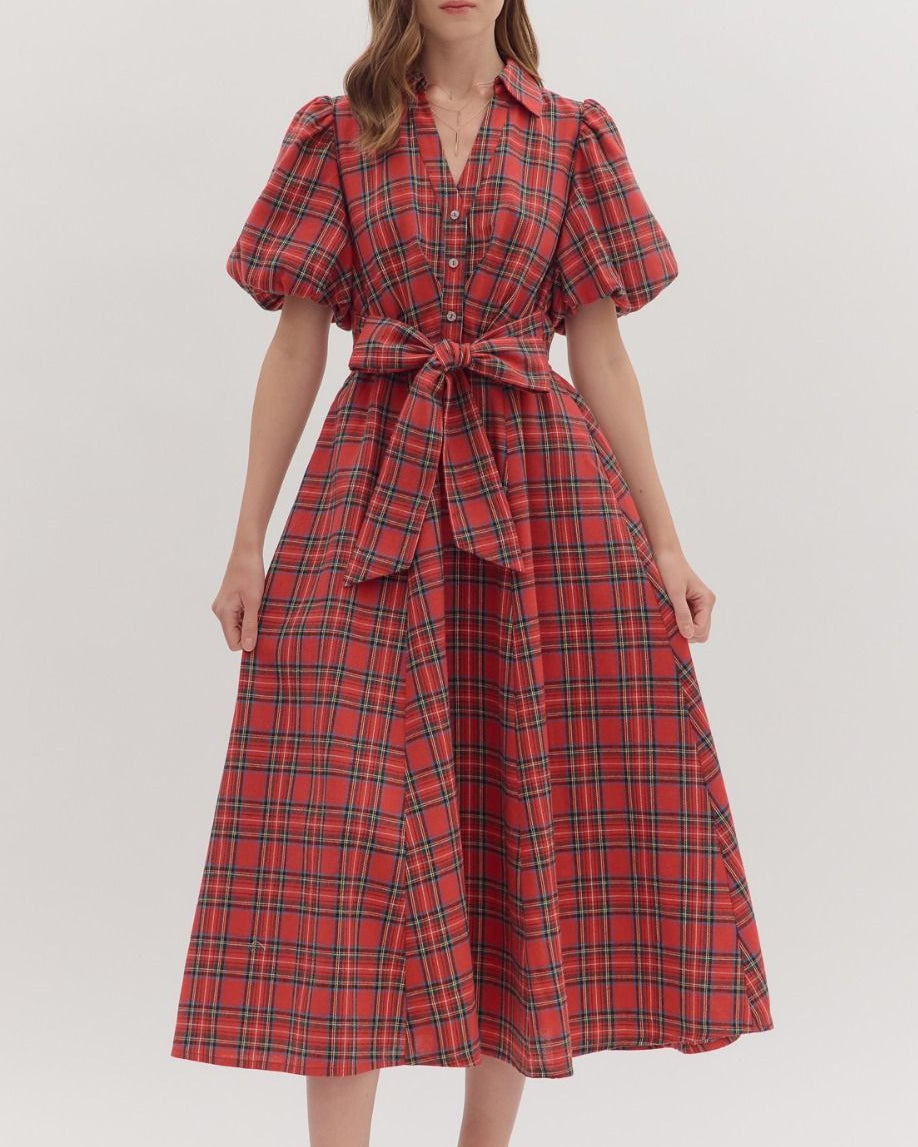 Woman wearing a red plaid dress on a white background