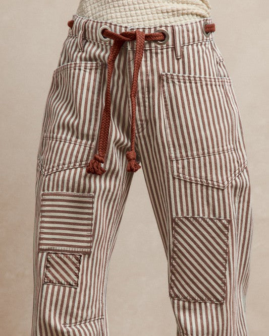 Striped pants with a drawstring on a beige background