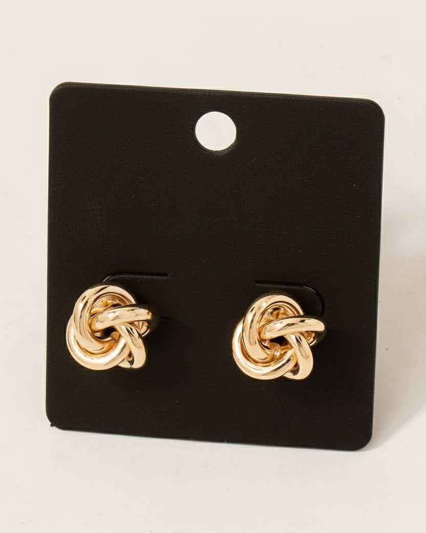 Gold knot earrings on a black card with 'made in Korea' text