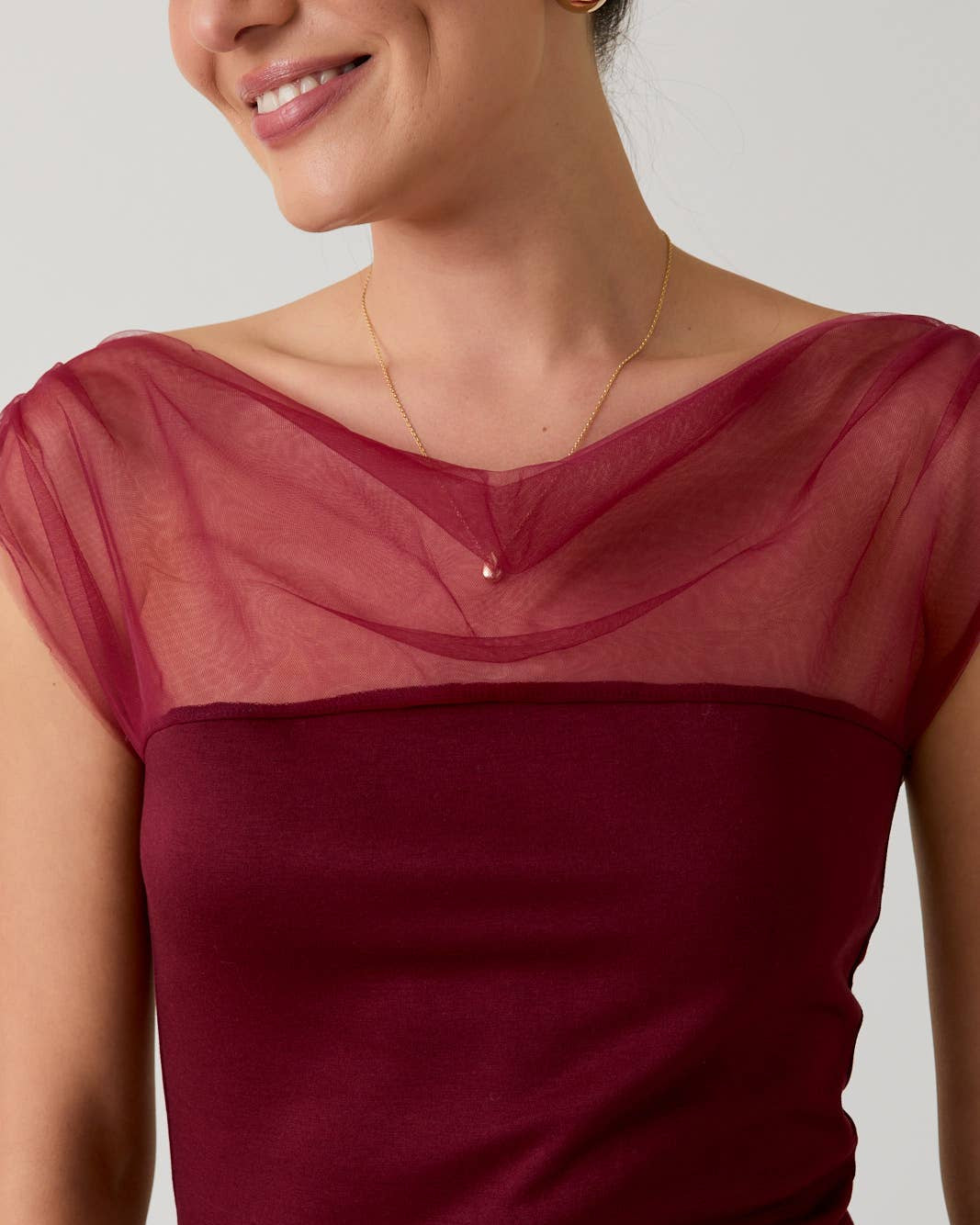 Red dress with sheer neckline on a plain background