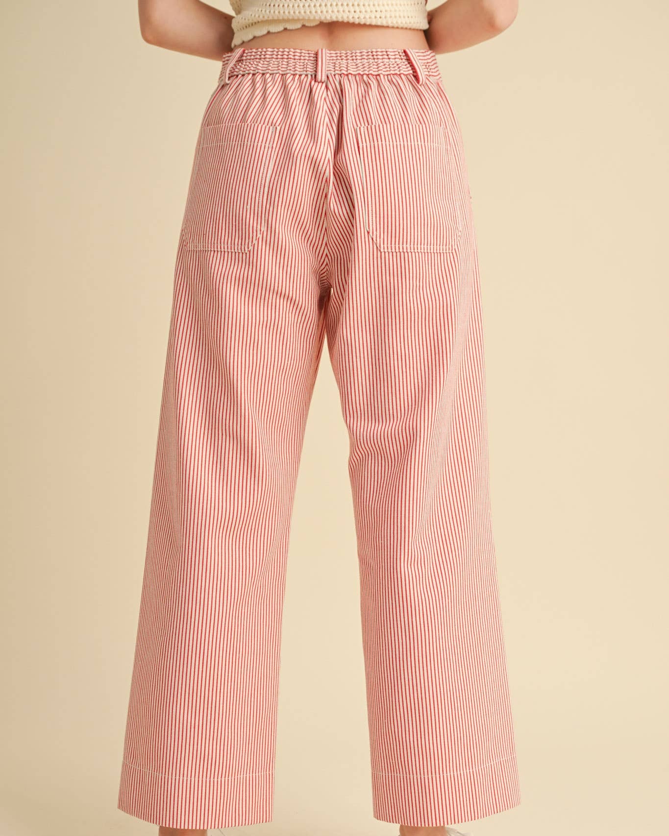 Wide leg cropped pants with red pinstripe on white. Back view