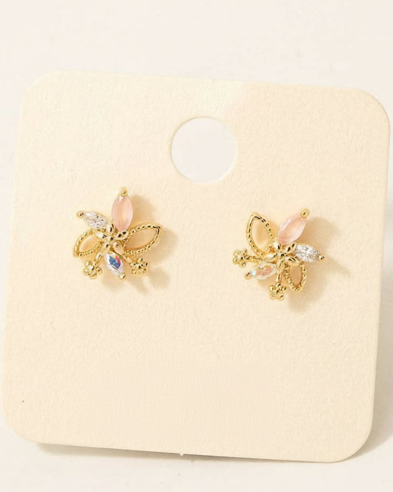 Butterfly-shaped earrings with pink stones on a beige card, labeled 'cubic zirconia' and 'Made in Korea'.