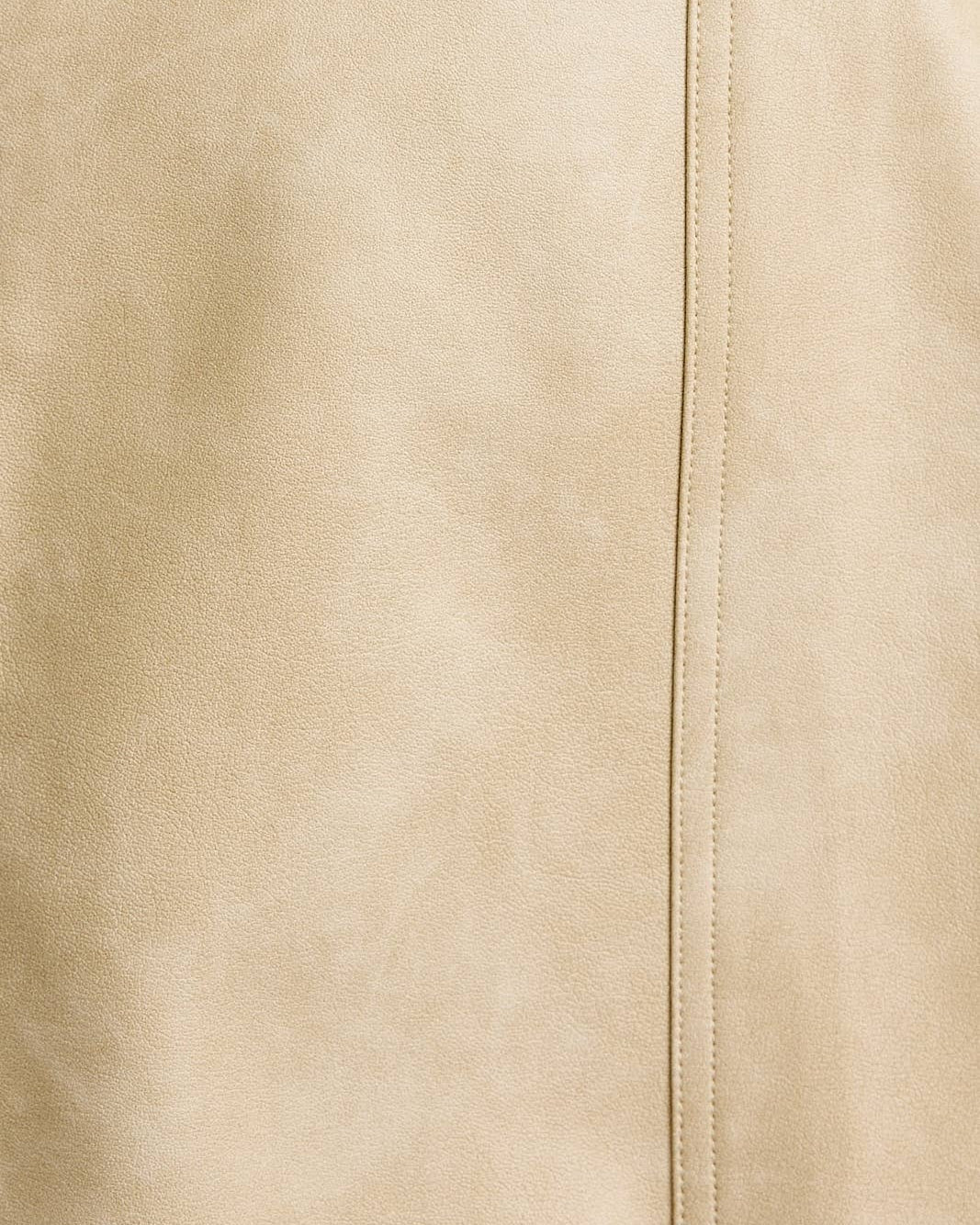 Close-up of beige fabric with a seam