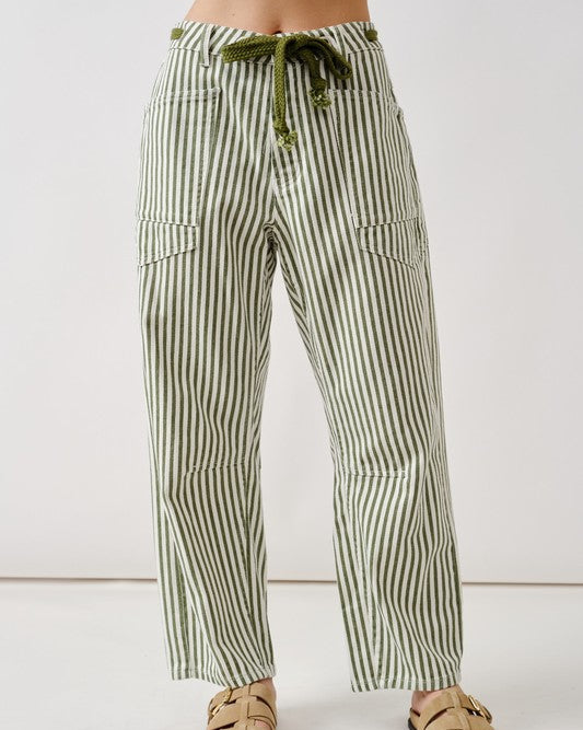 Green and white striped pants worn by a person on a white background