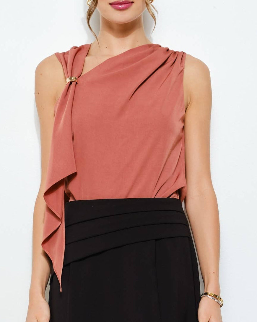 Woman wearing a pink top and black skirt on a white background