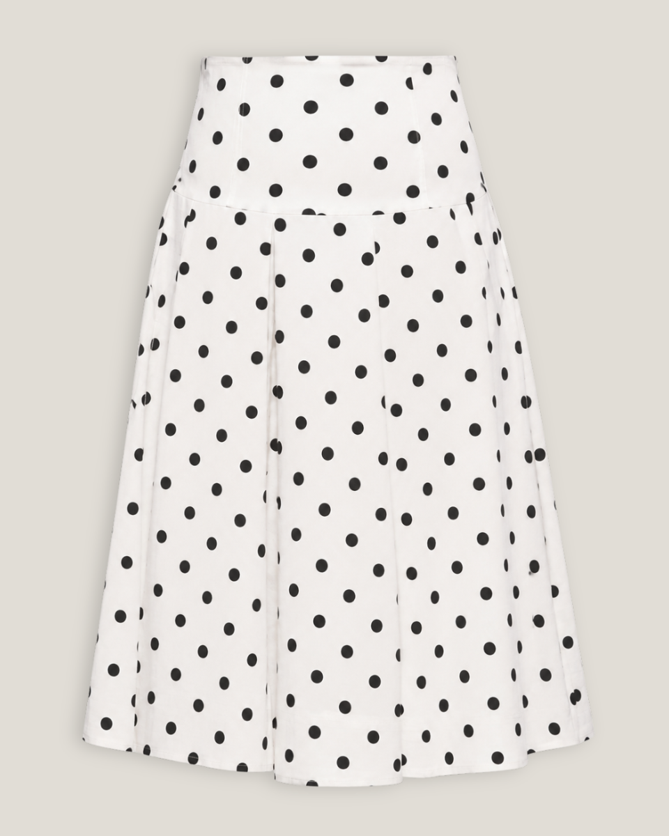 White skirt with black polka dots on a light gray background