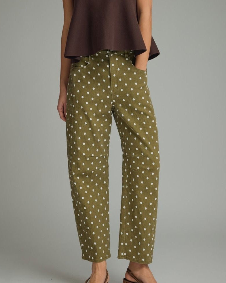 Model wearing Olive denim pants with white polka dots on a neutral background