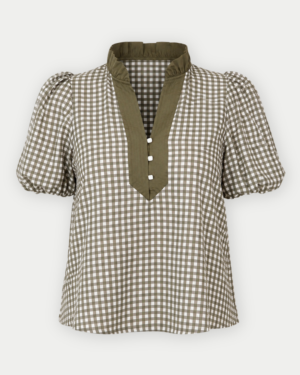 A women's short-sleeve blouse with a brown and white gingham pattern, featuring an olive green mock neck collar and a matching green button placket.