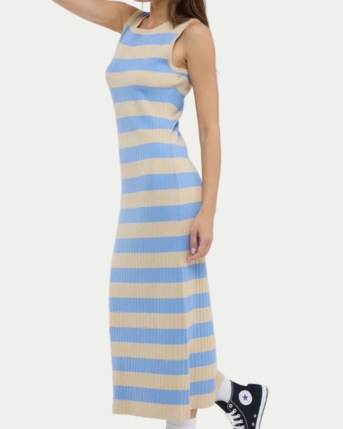 Woman wearing a blue and beige striped dress on a white background