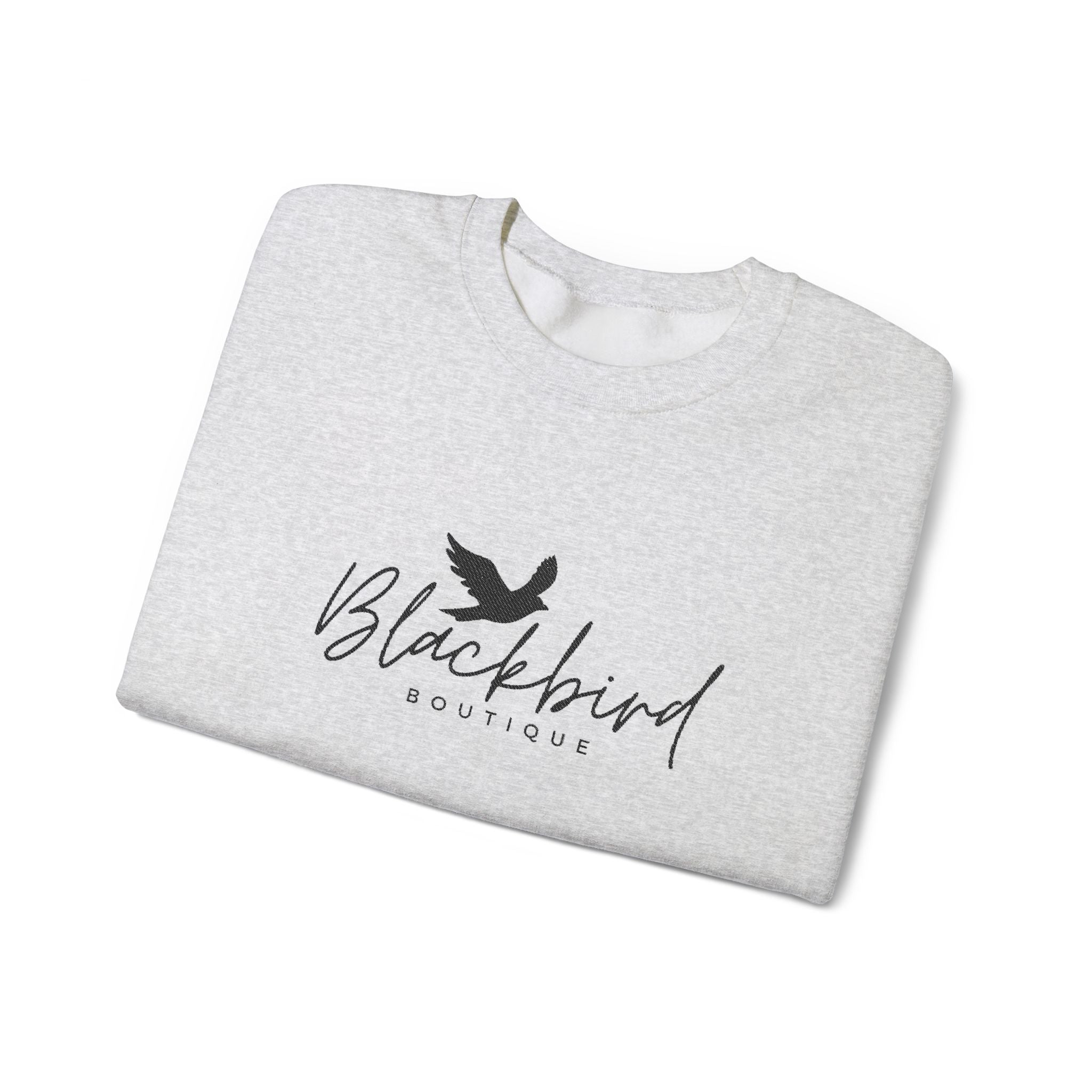 Folded gray t-shirt with a black silhouette design on a white background