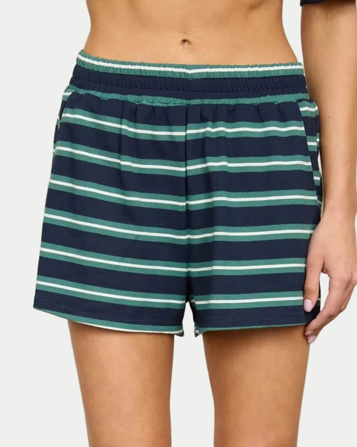 Person wearing navy/green striped shorts with a neutral background. Part of a set. Front view.