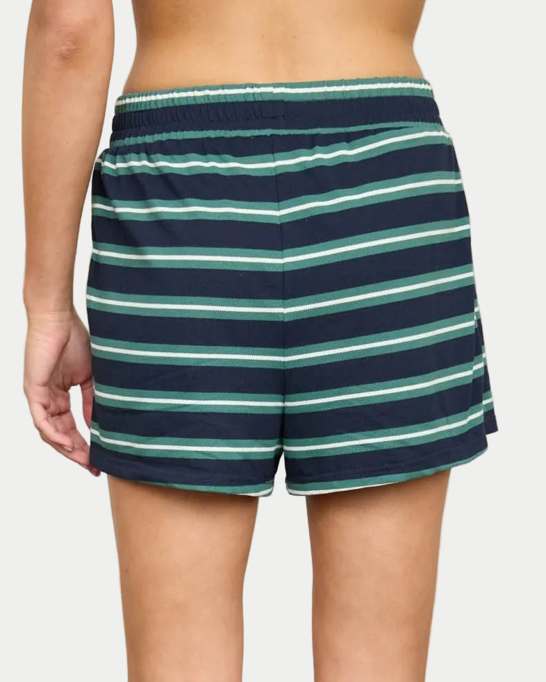 Person wearing navy/green striped shorts with a neutral background. Part of a set. back view.