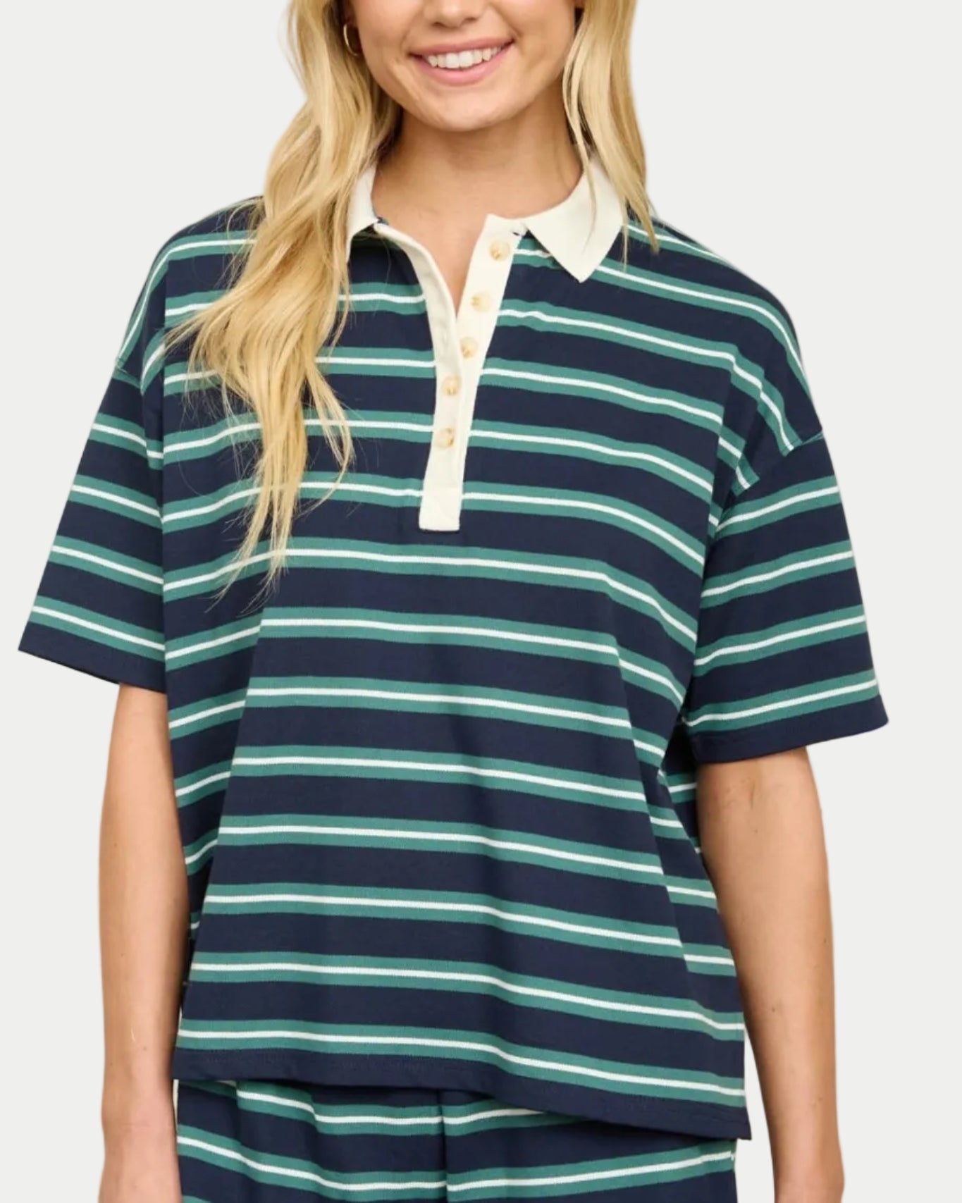Model wearing a navy/green striped polo shirt on a neutral background. Part of a set.