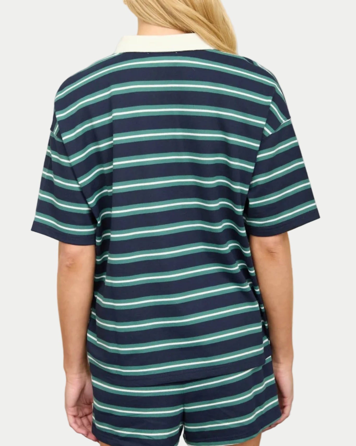Model wearing a navy/green striped polo shirt on a neutral background. Part of a set. Back view