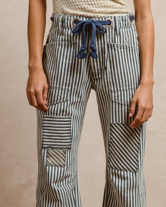 Striped pants with a drawstring waist on a beige background