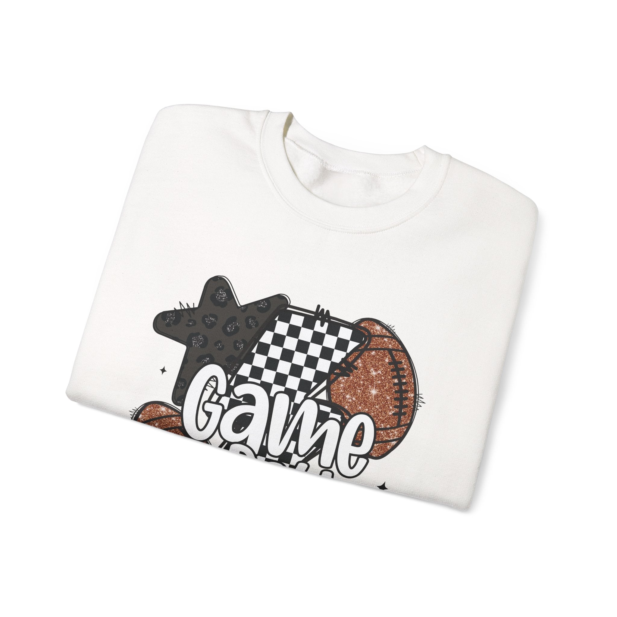 A folded white crewneck t-shirt with a graphic print featuring a star, a checkered lightning bolt, a football, and the word 'Game' in white script, displayed on a clean white background.