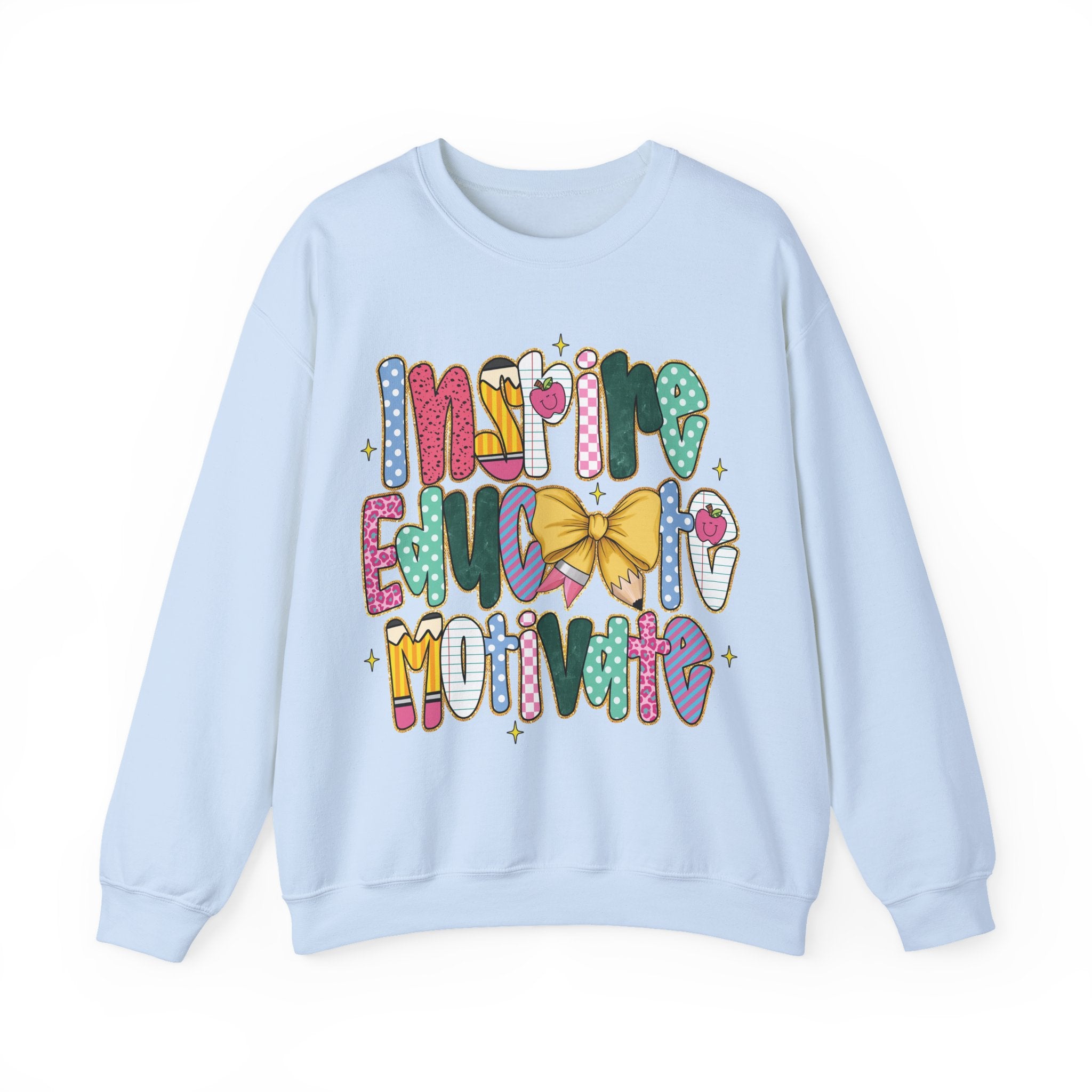 A light blue crewneck sweatshirt featuring a colorful graphic on the front that reads 'inspire educate motivate' in playful patterned letters with a yellow bow and small stars.