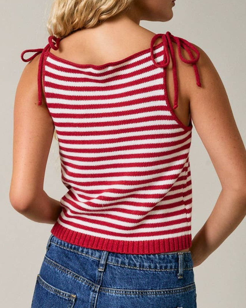 Model wearing a red and white striped sleeveless top on a neutral background back view