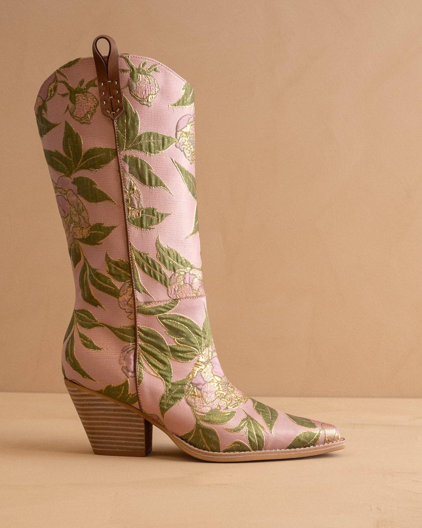 Pink floral patterned boots on a beige background