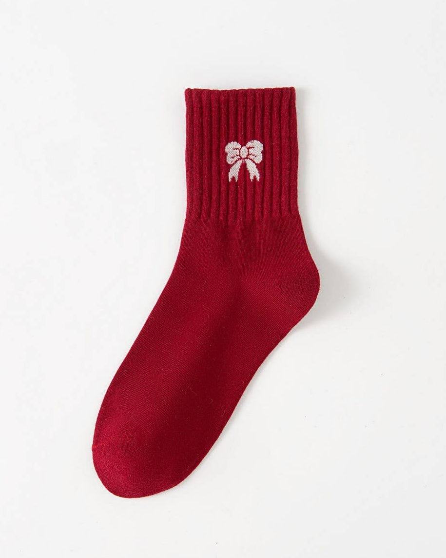 Red sock with a white bow design on a white background