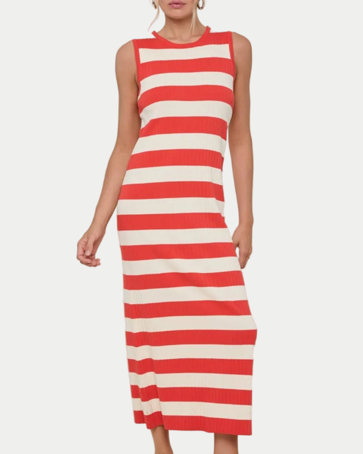 Woman wearing a papaya and white striped dress on a beige background