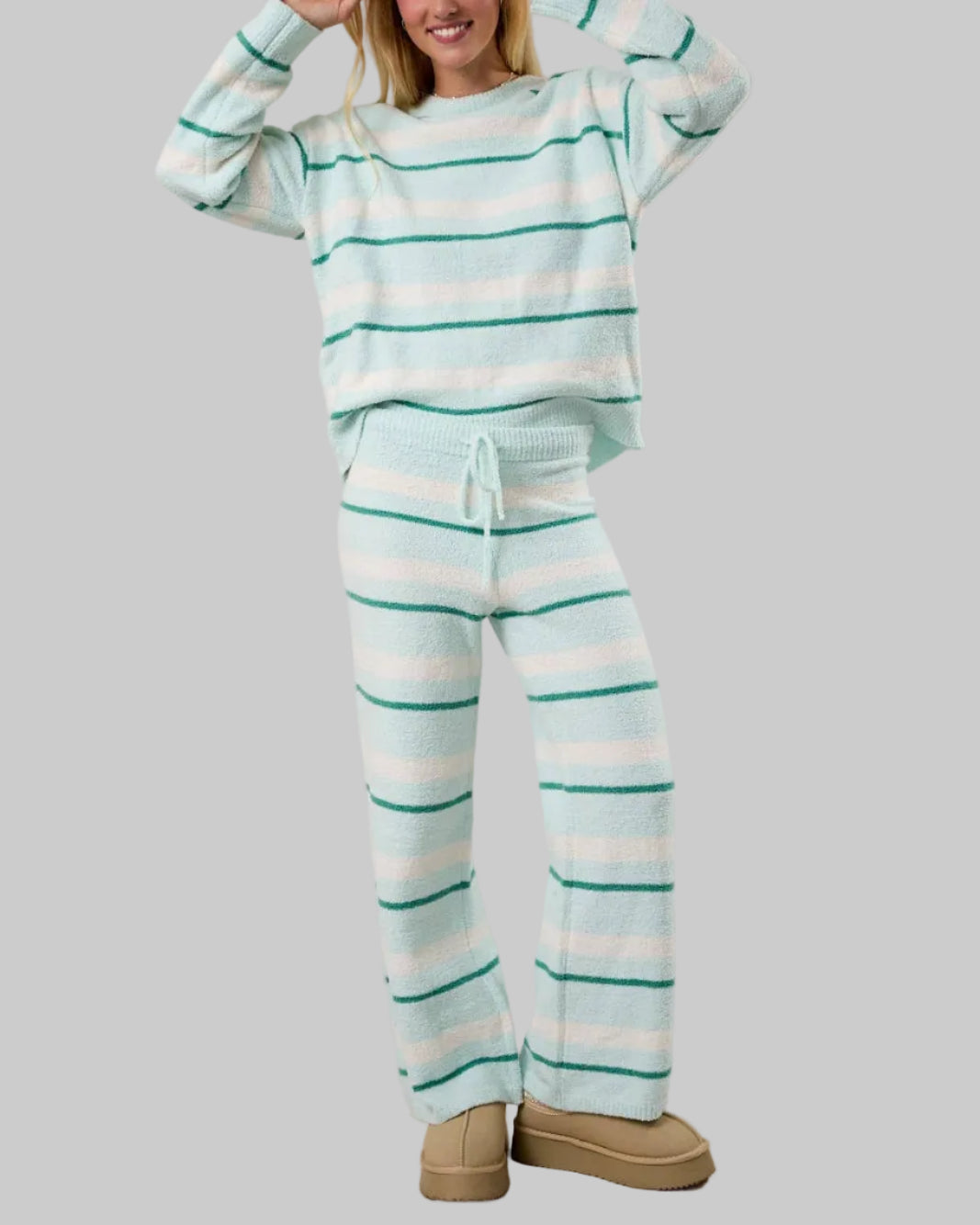 Person wearing a striped pajama set with a plain background