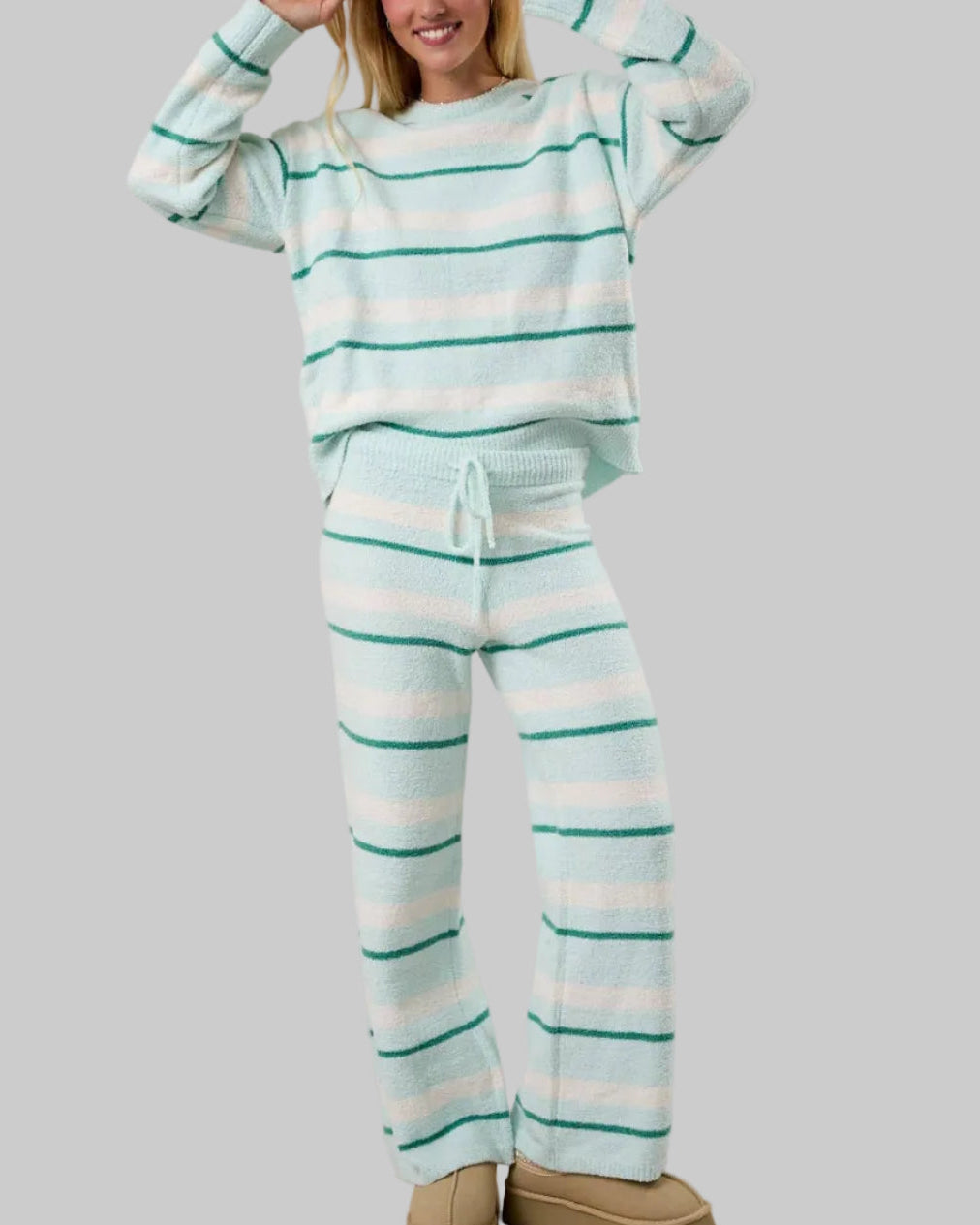 Person wearing a striped pajama set with a plain background
