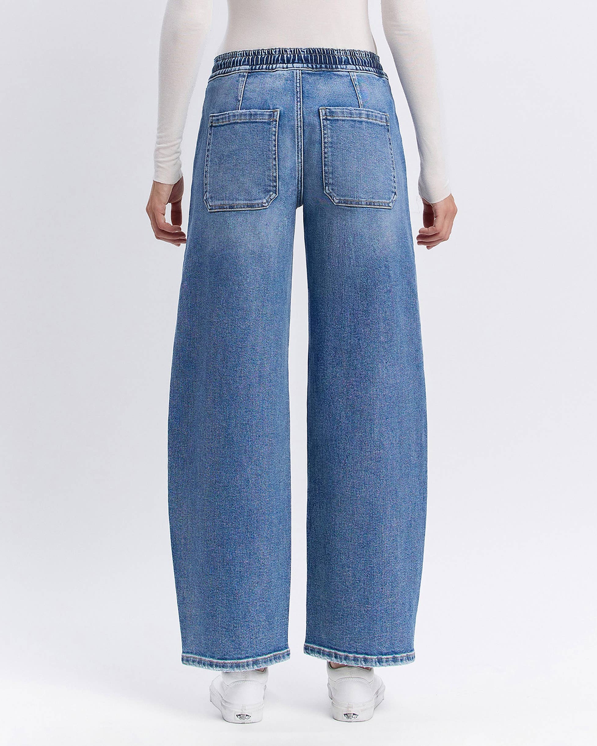 Blue jeans worn by a person on a white background