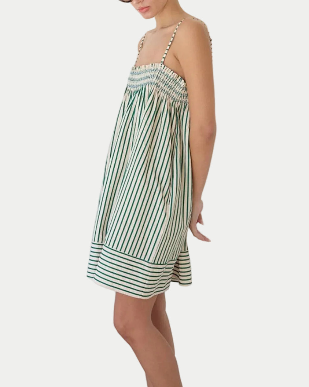 Green Stripe Babydoll Dress on a model side view with a white background