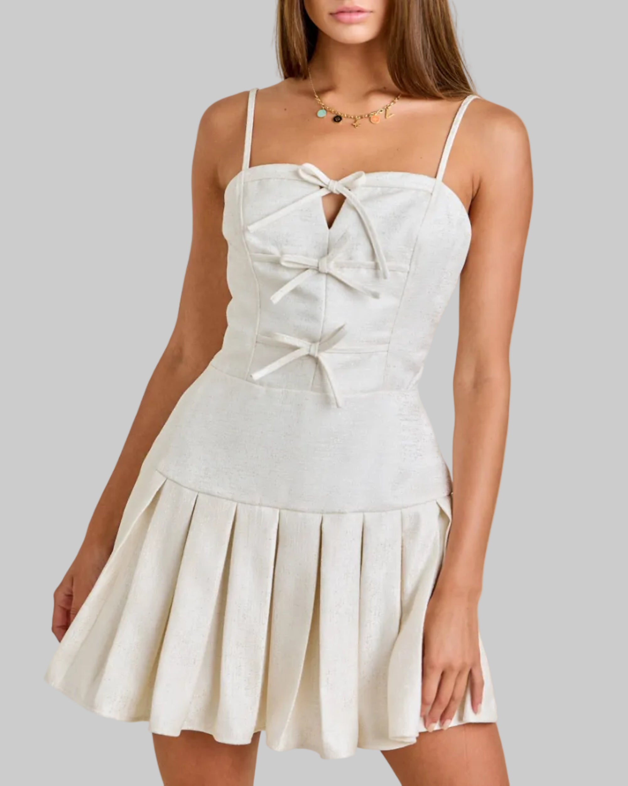 Woman wearing a white dress with a beige background