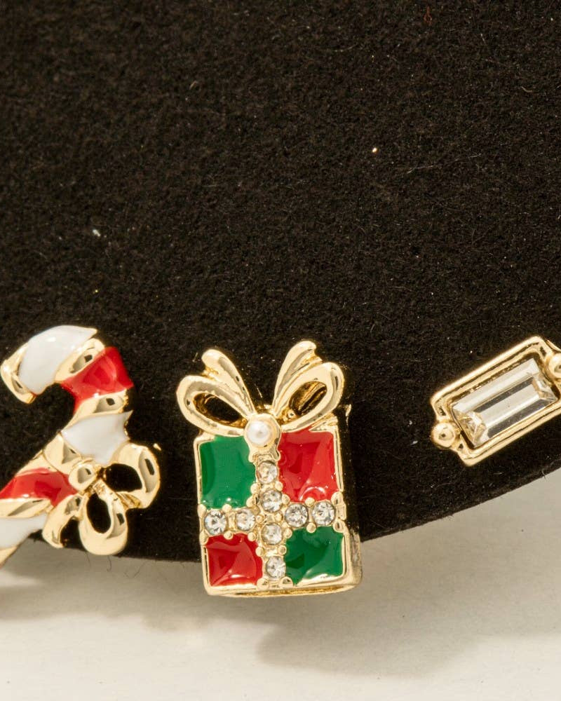 Two festive earrings on a black background