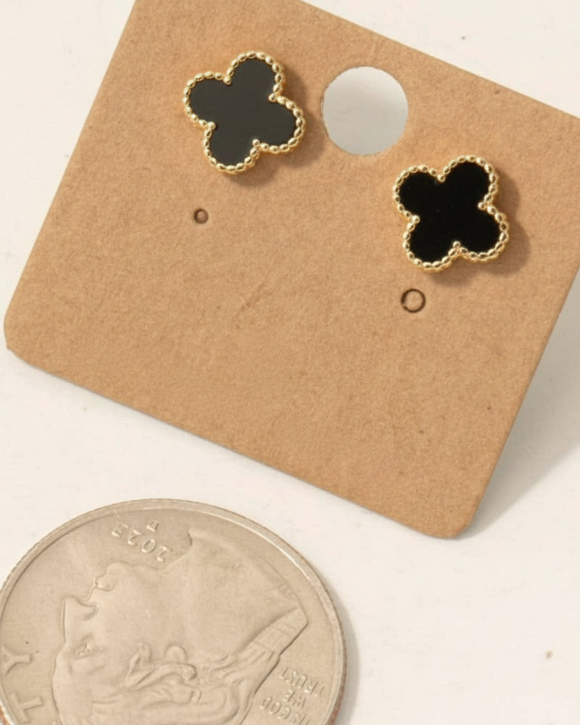Clover-shaped earrings on a brown card with '18K Gold Dipped' text, next to a quarter for scale.