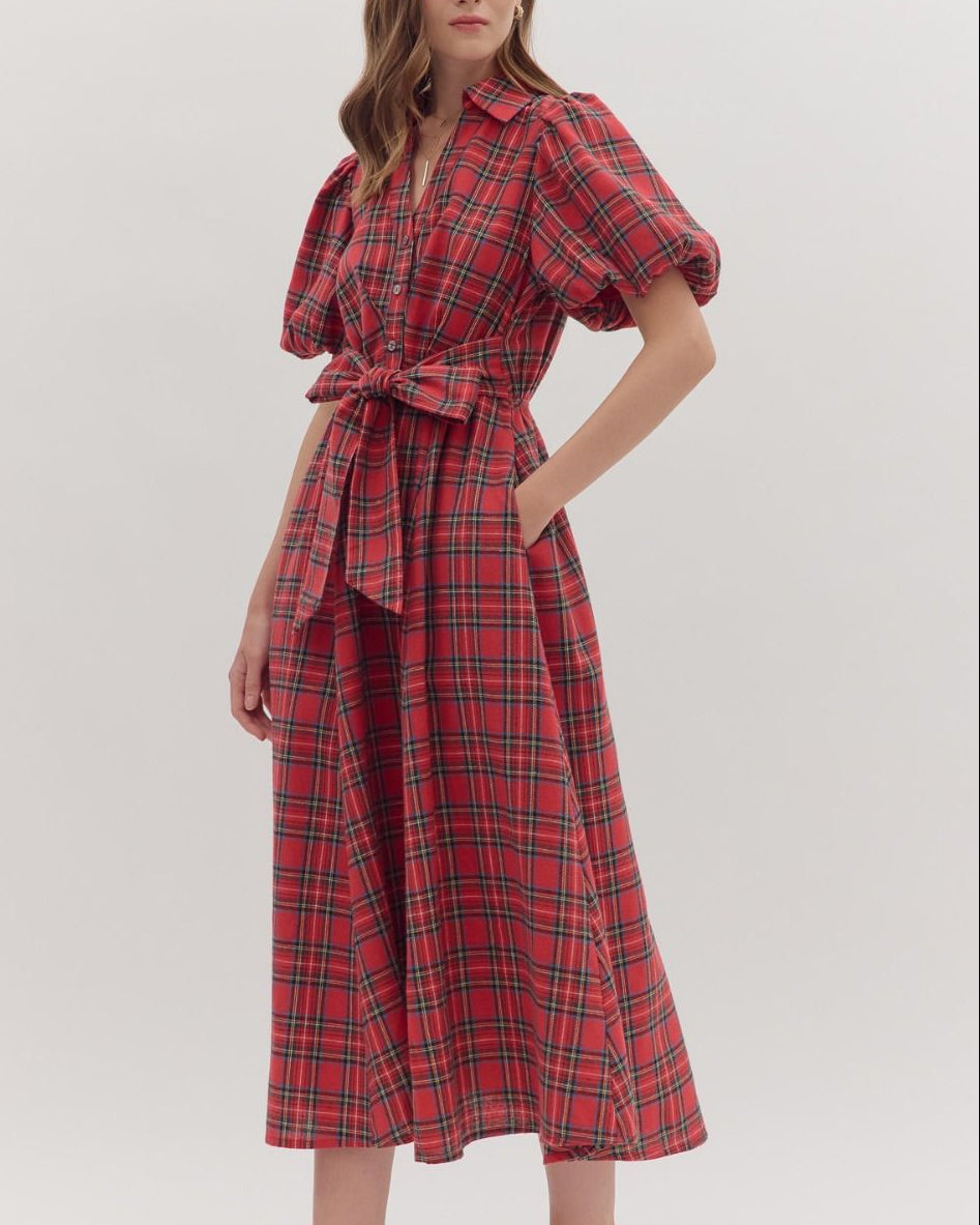 Woman wearing a red plaid dress on a white background