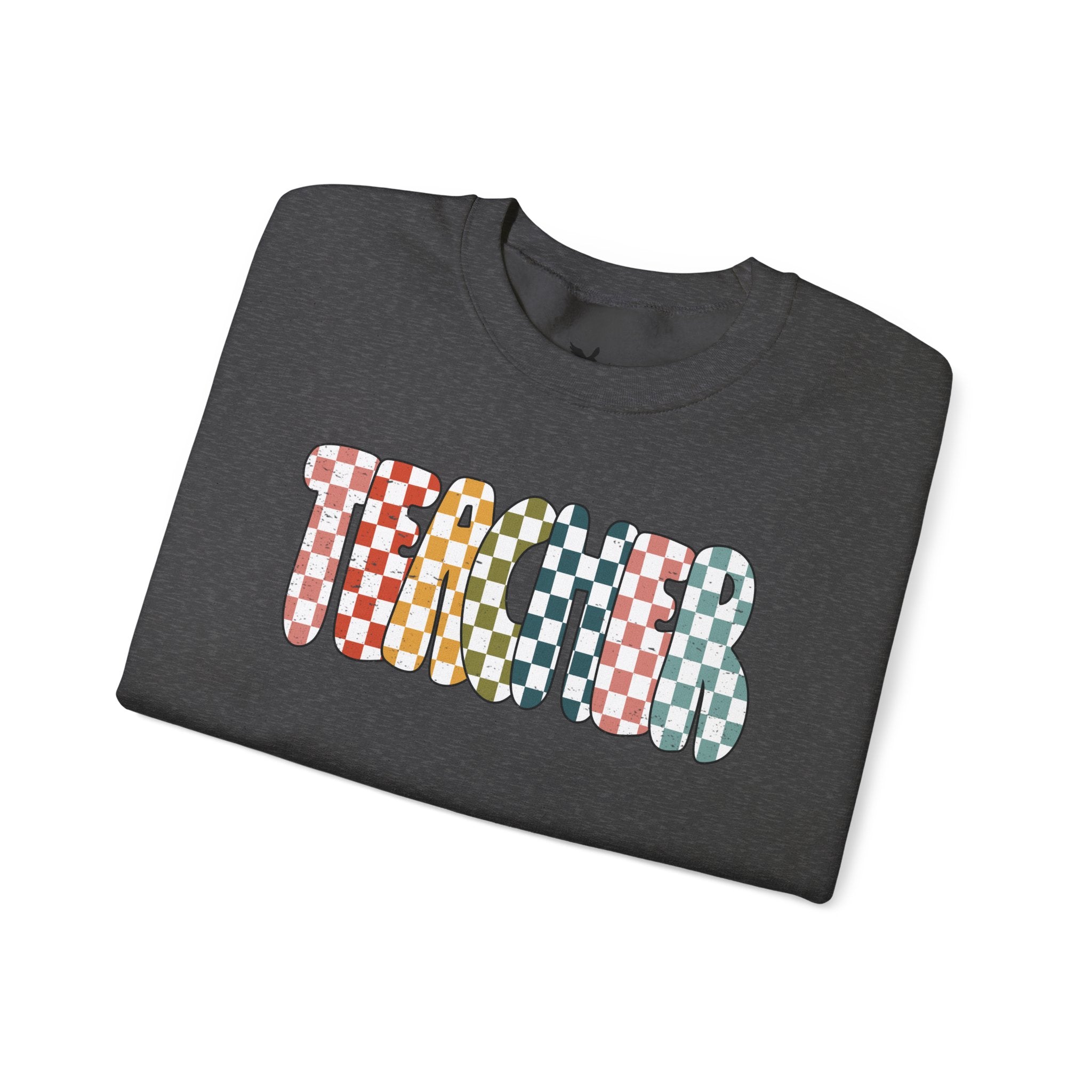 Folded gray t-shirt with white 'TEACHER' graphic design on a white background