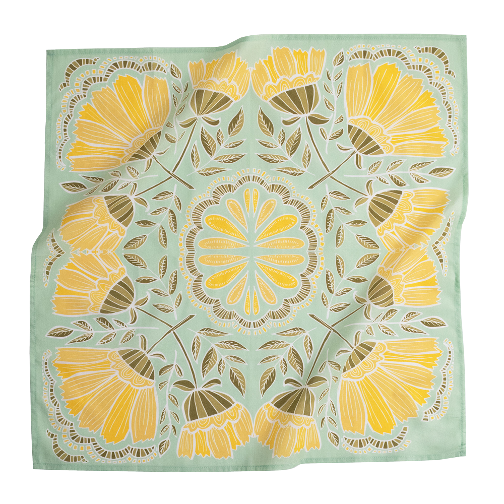 Floral patterned fabric with yellow flowers on a light green background