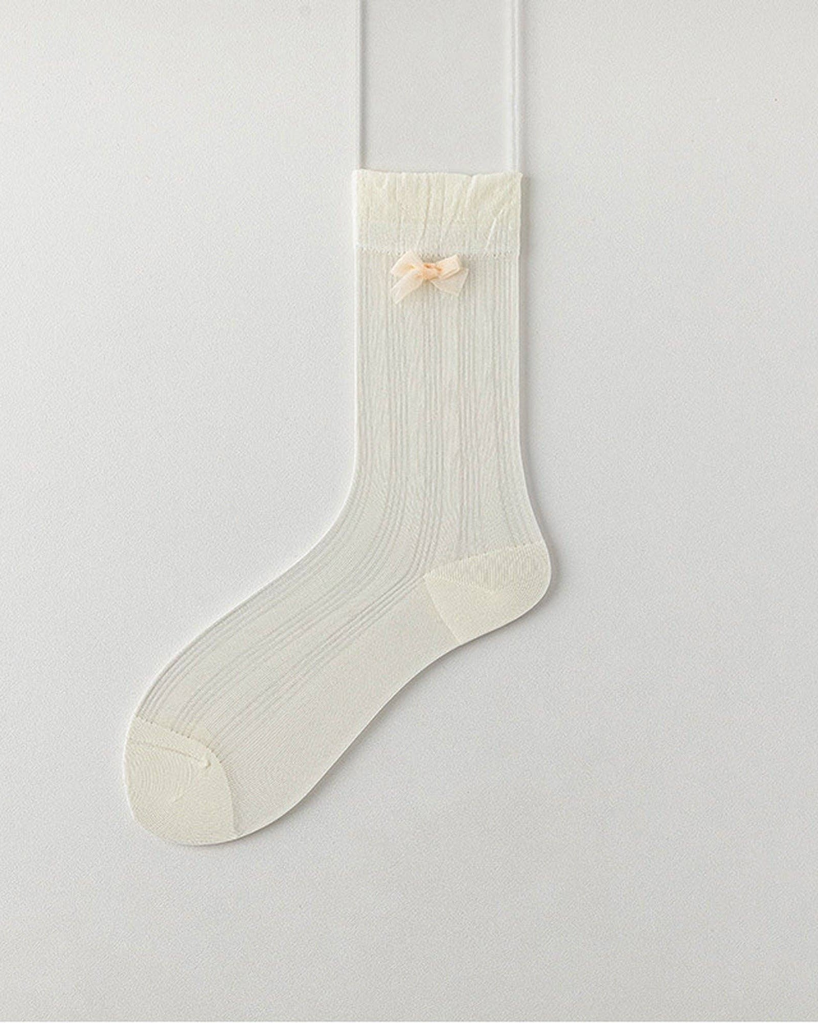White sock with a small bow on a light gray background