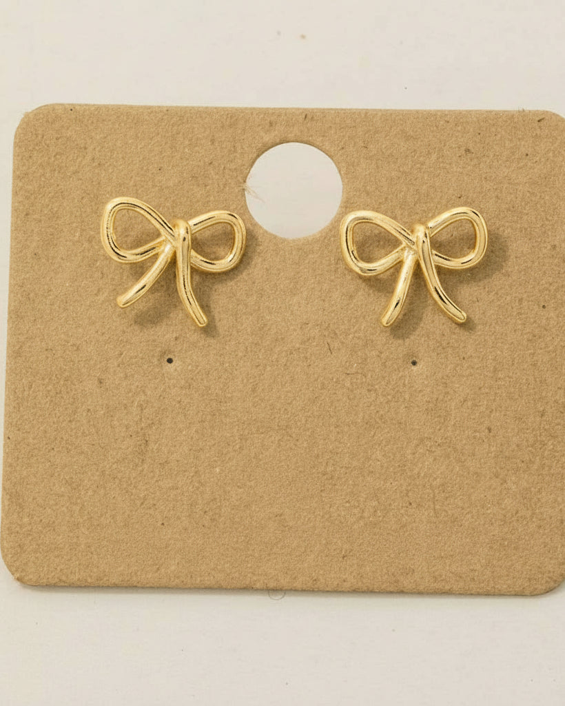 Gold bow-shaped earrings on a kraft paper card with '18K Gold Dipped' text.