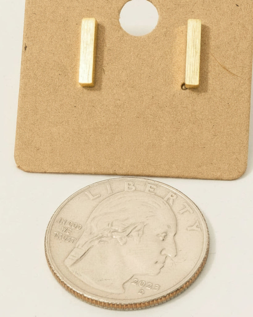 Gold-dipped bar earrings on a cardboard backing with '18K Gold Dipped' text, next to a U.S. quarter coin for size comparison.
