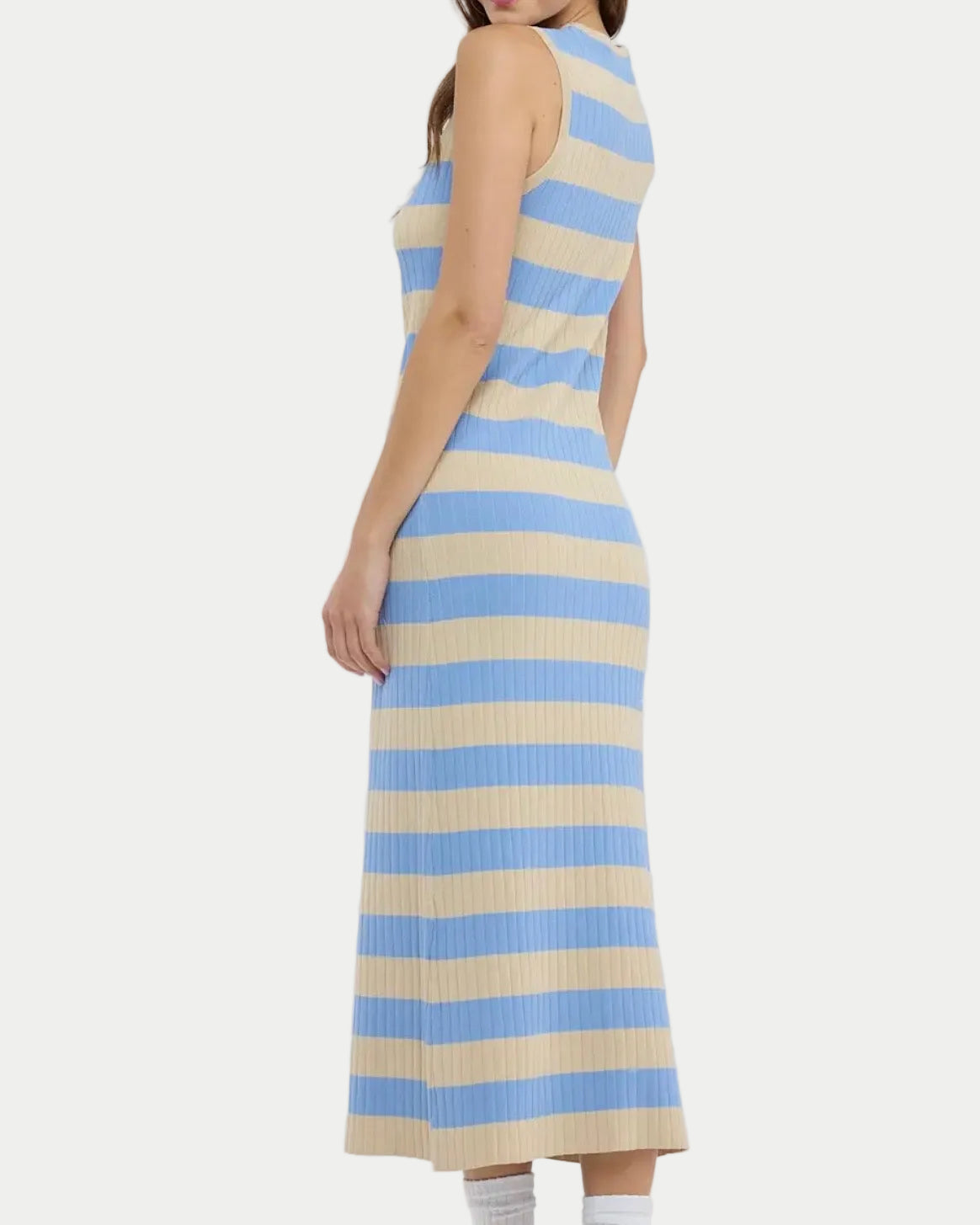 Woman wearing a sleeveless dress with blue and beige stripes on a white background