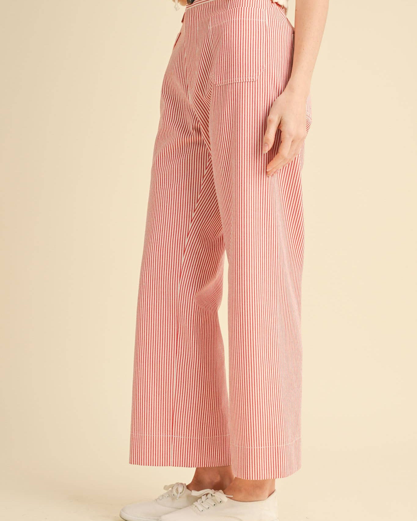 Wide leg cropped pants with red pinstripe on white.  Side view