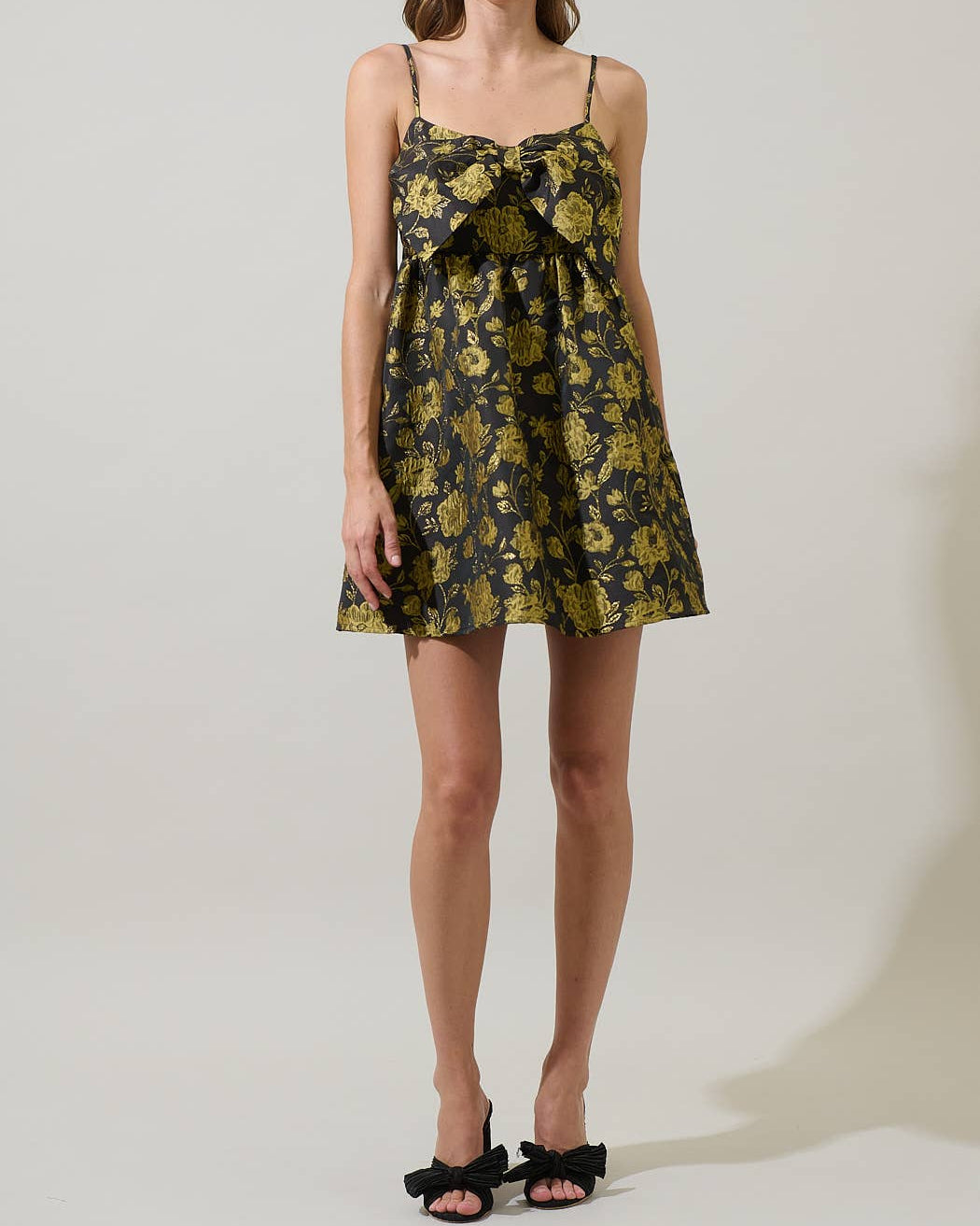 Woman wearing a floral dress on a plain background