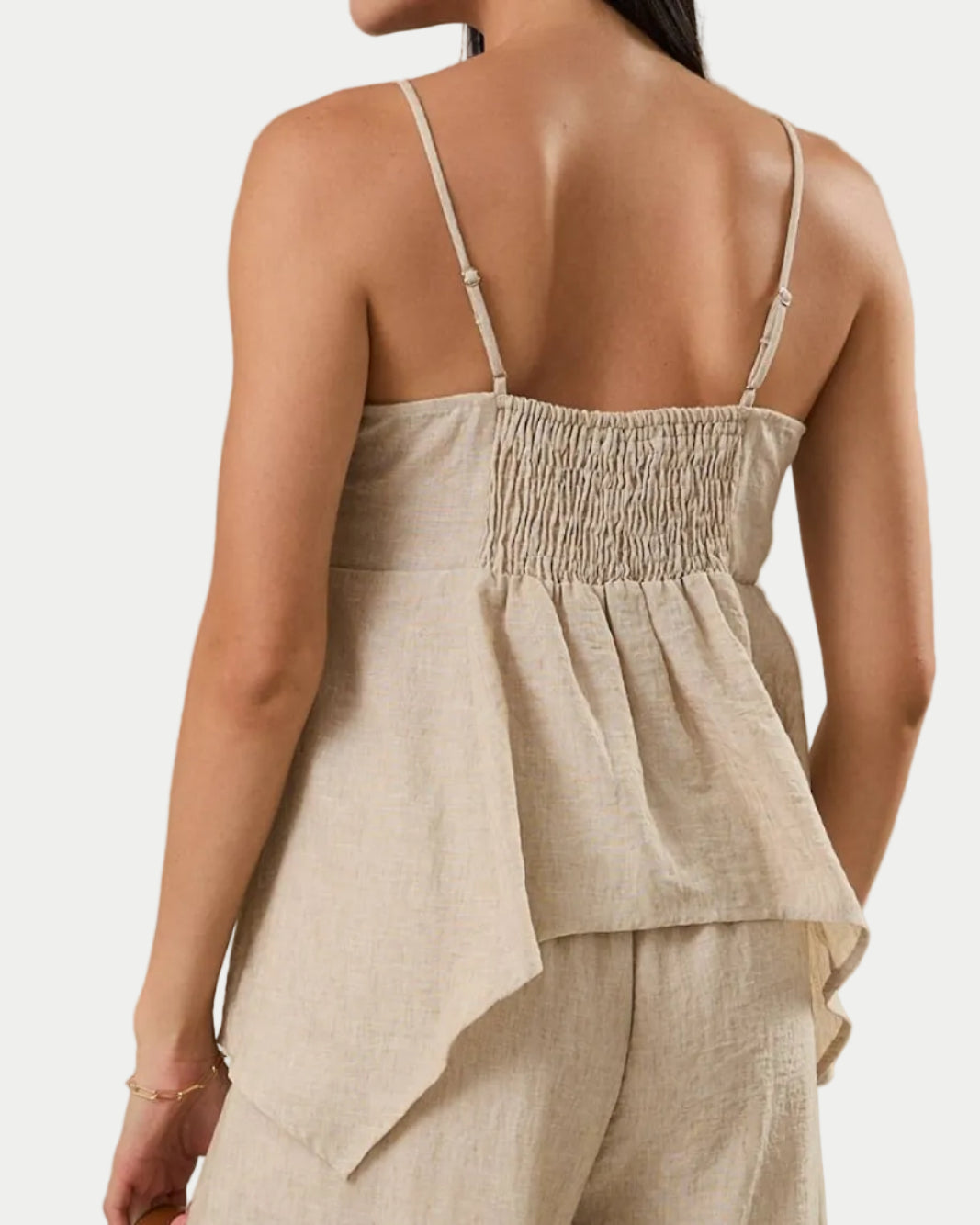 SLEEVELESS BACK SMOCKING HANKY HEM TOP.  back view on a model with a neutral background.  Summer ready style for parties, graduation guests, date night and brunch  - Blackbird Boutiquee