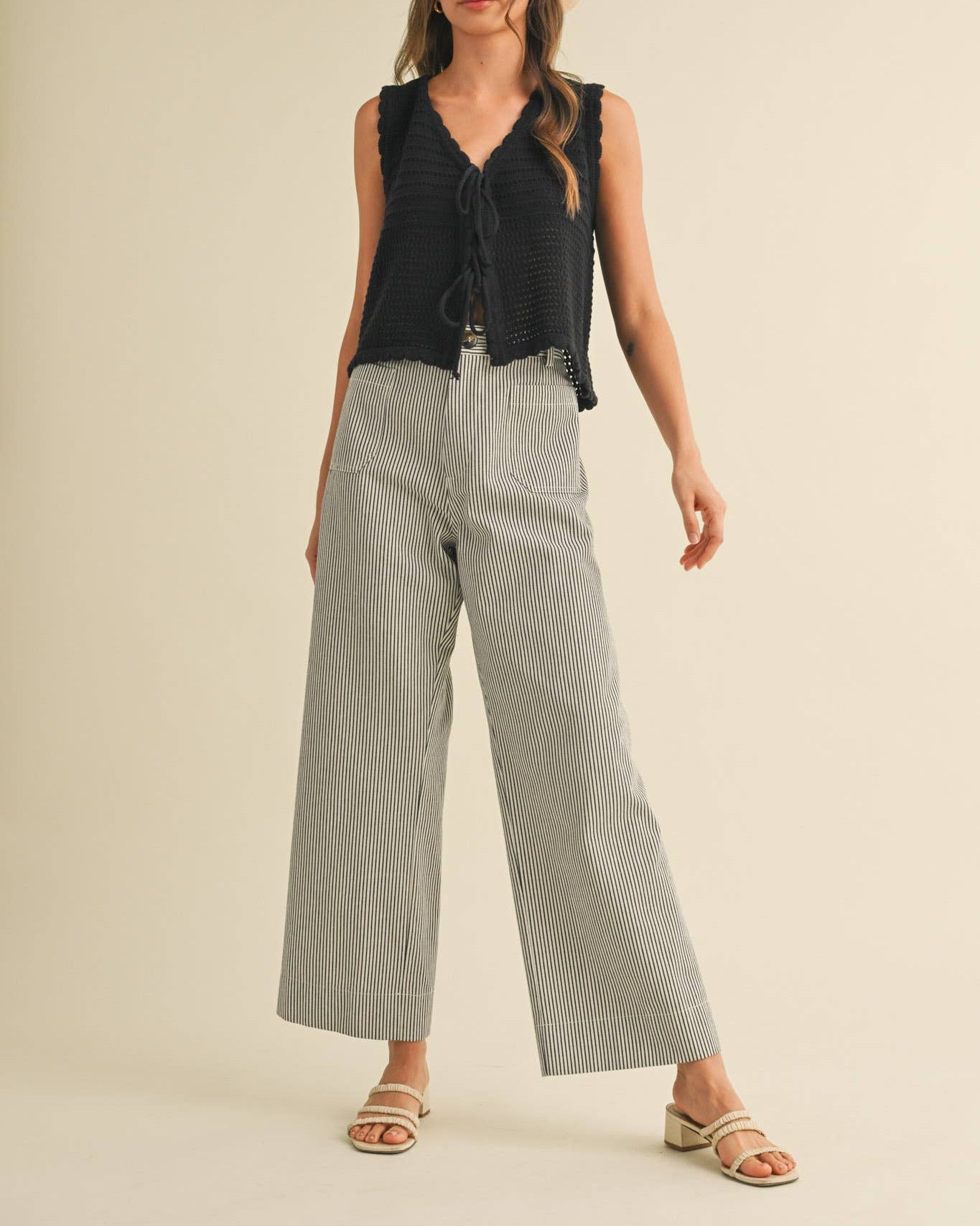 Wide leg pant with black pinstripe on white.  Front view